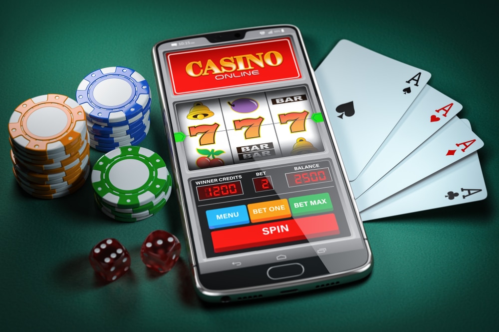 Prikaz online kazina na mobilnom telefonu, karte za poker, kockice i žetoni